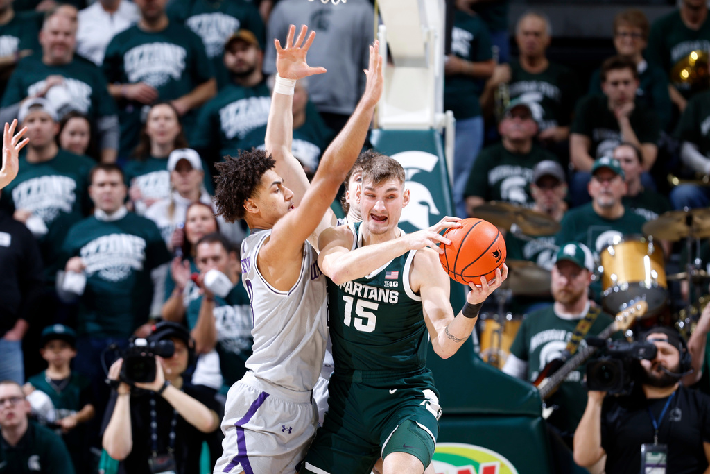 Michigan State center Carson Cooper (15) maneuvers against Northwestern forward Tre Singleton, left, during the first half of an NCAA college basketball game, Thursday, Jan. 8, 2026, in East Lansing, Mich. (AP Photo/Al Goldis)