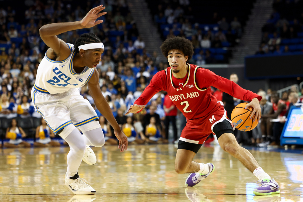Maryland guard Myles Rice (2) dribbles against UCLA center Steven Jamerson II, left, during the first half of an NCAA college basketball game, Saturday, Jan. 10, 2026, in Los Angeles. (AP Photo/Jessie Alcheh)