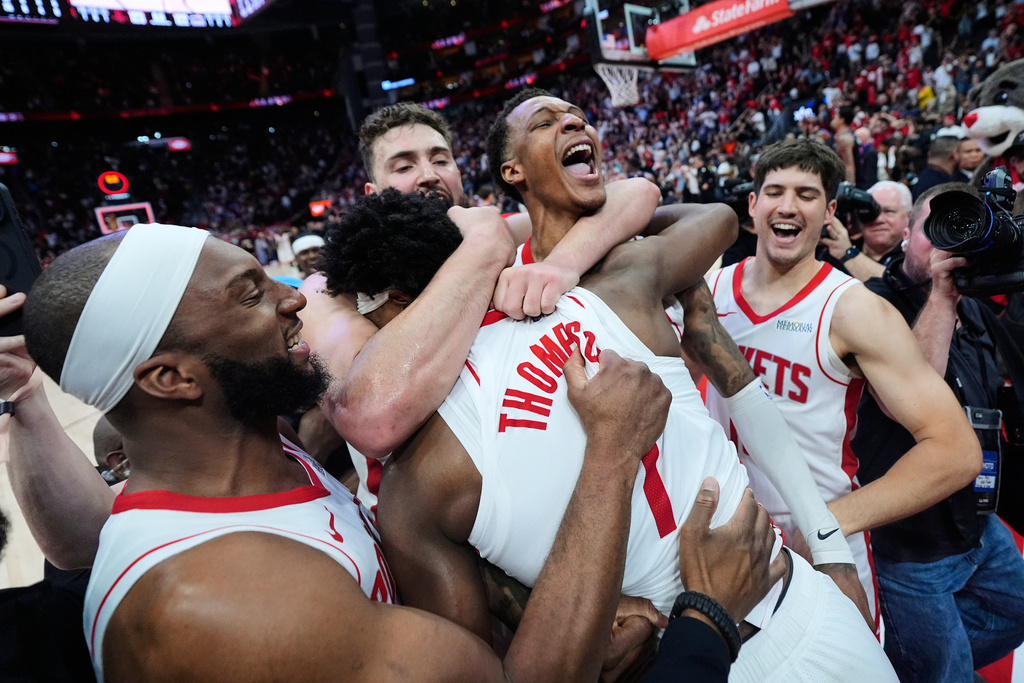 Houston Rockets guard Amen Thompson (1) celebrates with teammates after making a shot to win an NBA basketball game against the Miami Heat in Houston, Saturday, March 21, 2026. (AP Photo/Ashley Landis)