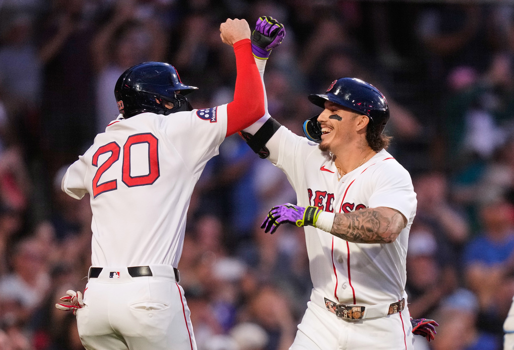 Boston Red Sox's Jarren Duran, right, is congratulated by Nick Sogard (20) after hitting a two-run home run during the second inning of a baseball game against the Seattle Mariners, Monday, Aug. 31, 2026, in Boston. (AP Photo/Charles Krupa)
