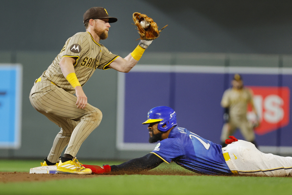 Minnesota Twins' Byron Buxton, right, steals second base as San Diego Padres second baseman Jake Cronenworth, left, takes the throw in the fourth inning of a baseball game Friday, Aug. 29, 2025, in Minneapolis. (AP Photo/Bruce Kluckhohn)