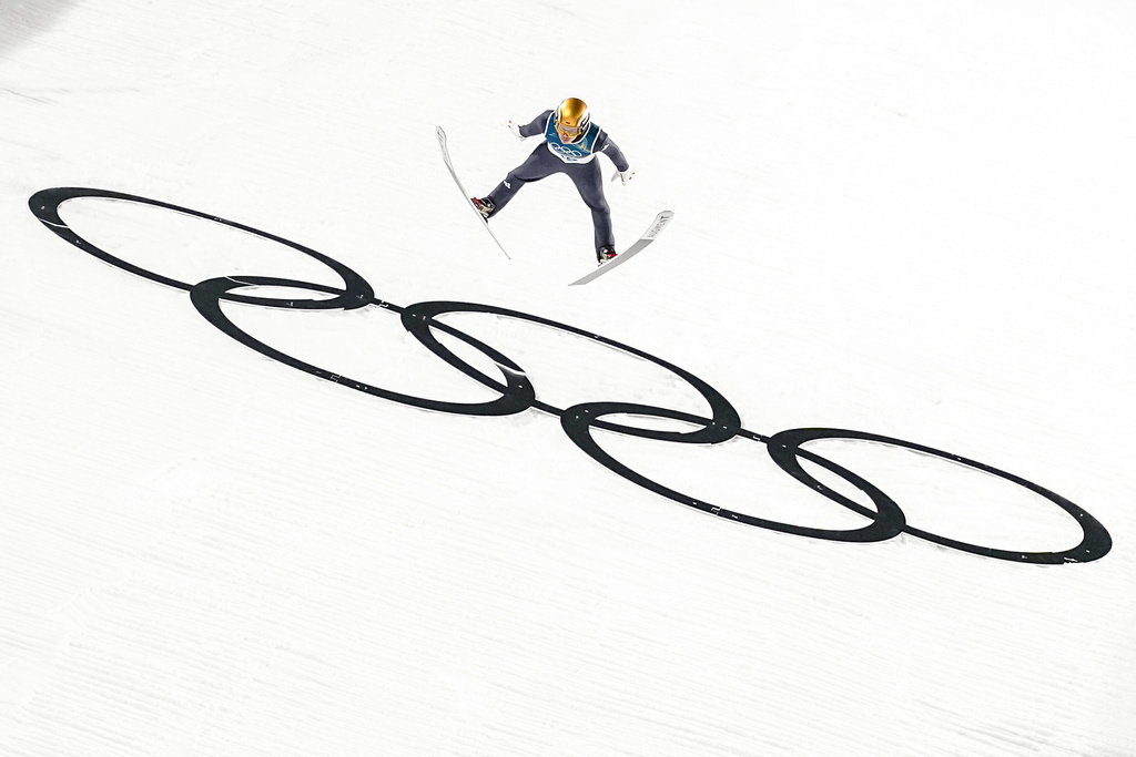 Philipp Raimund, of Germany, soars through the air during his final round jump in the ski jumping men's normal hill individual at the 2026 Winter Olympics, in Predazzo, Italy, Monday, Feb. 9, 2026. (AP Photo/Matthias Schrader)
