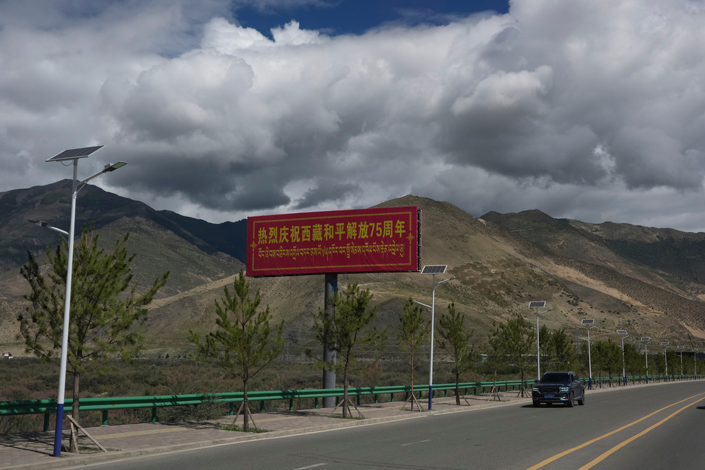 A billboard with the words "Warmly celebrating the 75th anniversary of the peaceful liberation of Tibet" is seen on a highway near Shannan in western China's Tibet Autonomous Region on Thursday, July 23, 2026, as seen during a government organized visit for foreign journalists. (AP Photo/Ng Han Guan)
