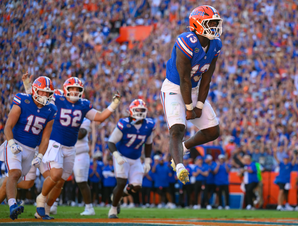 Florida running back Jadan Baugh (13) jumps in celebration after rushing for a touchdown during the first half of an NCAA college football game against Mississippi, Saturday, Sept. 26, 2026, in Gainesville, Fla. (AP Photo/Noah Lantor)