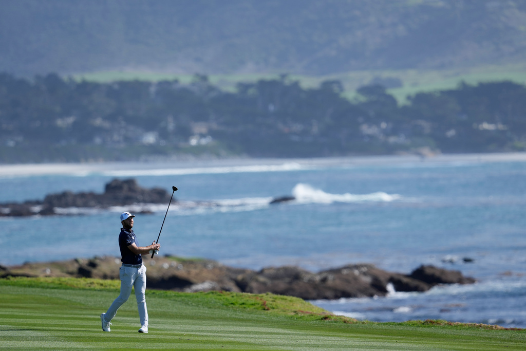 Sam Burns hits from the 18th fairway at Pebble Beach Golf Links during the first round of the AT&T Pebble Beach Pro-Am golf tournament in Pebble Beach, Calif., Thursday, Feb. 12, 2026. (AP Photo/Godofredo A. Vásquez)