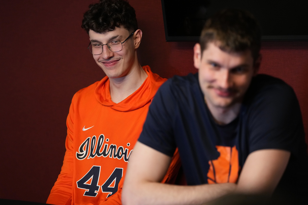 Illinois center Zvonimir Ivisic, left, listens as brother and teammate Tomislav Ivisic, right, answer questions during a news conference for the Elite Eight of the NCAA college basketball tournament, Friday, March 27, 2026, in Austin, Texas. (AP Photo/Eric Gay)
