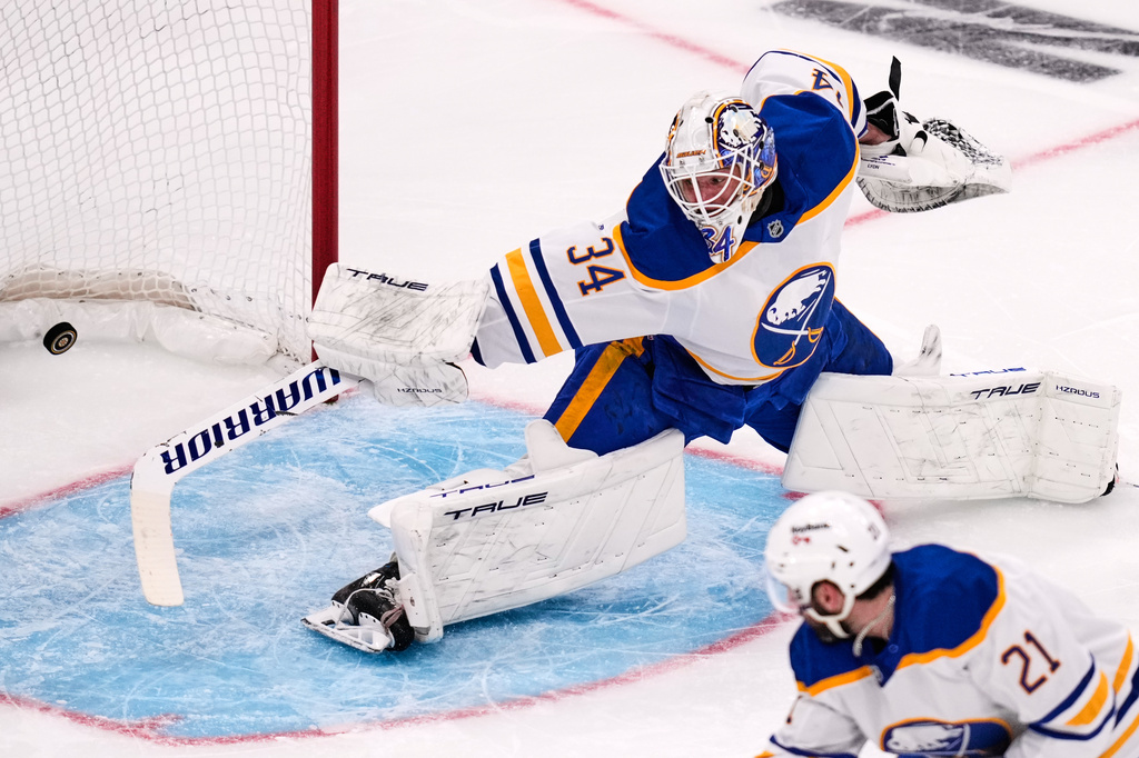 Buffalo Sabres goaltender Alex Lyon (34) stretches but cannot make a save on a goal by Boston Bruins right wing David Pastrnak (not shown) during the second period in Game 6 of a first-round NHL hockey Stanley Cup playoff series, Friday, May 1, 2026, in Boston. (AP Photo/Charles Krupa)