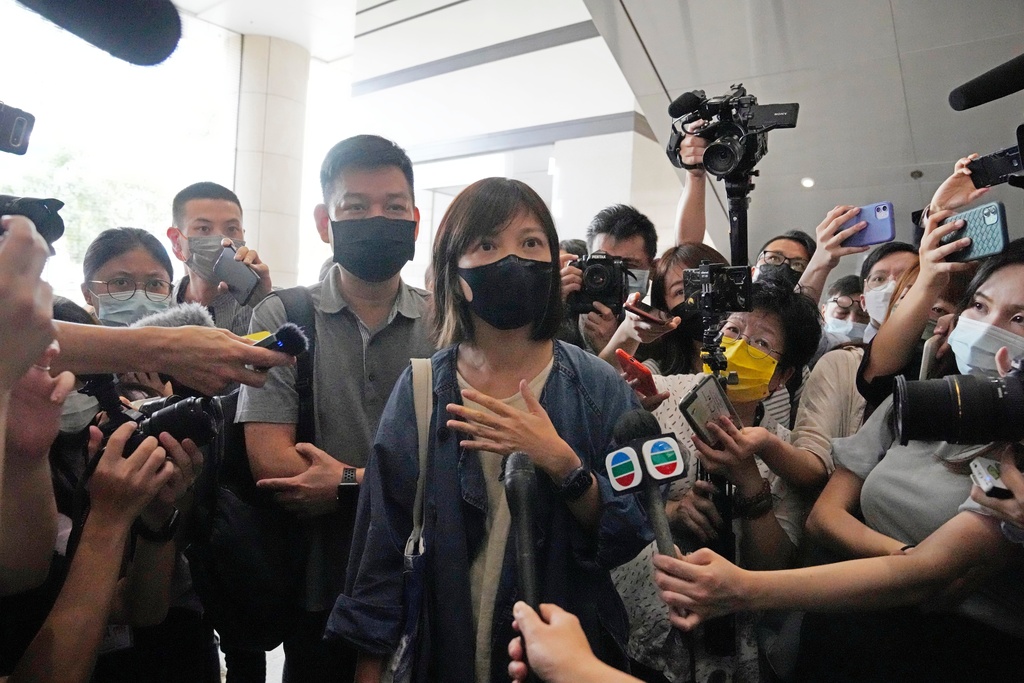 FILE - Chan Pui-man, associate publisher of Apple Daily newspaper walks out from a court in Hong Kong, June 19, 2021. (AP Photo/Kin Cheung), File)