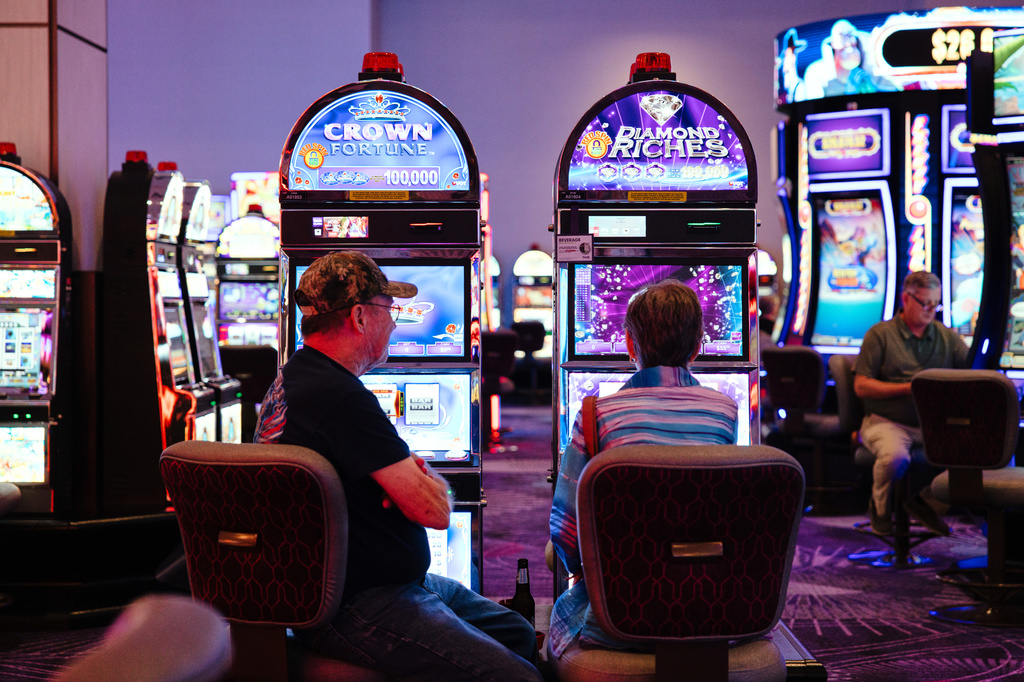 People play slot machines at Harrah's Casino, owned by the Iowa Tribe of Oklahoma, in Chandler, Okla., Wednesday, Aug. 5, 2026. (AP Photo/Brittany Bendabout)