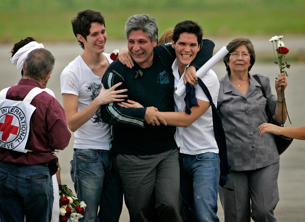 FILE - Freed hostage Sigifredo Lopez reunites with his family after his release from the Revolutionary Armed Forces of Colombia, or FARC, in Cali, Colombia, Feb. 5, 2009. Lopez was kidnapped in 2002 along with 11 fellow lawmakers and was the sole survivor after the others were killed in captivity. (AP Photo/Christian Escobar Mora, File)