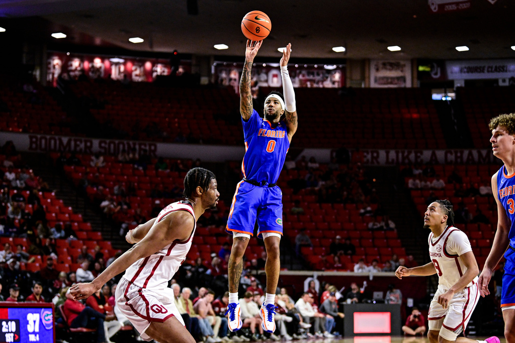 Florida guard Boogie Fland (0) shoots against Oklahoma during the first half of an NCAA college basketball game, Tuesday, Jan. 13, 2026, in Norman, Okla. (AP Photo/Gerald Leong)