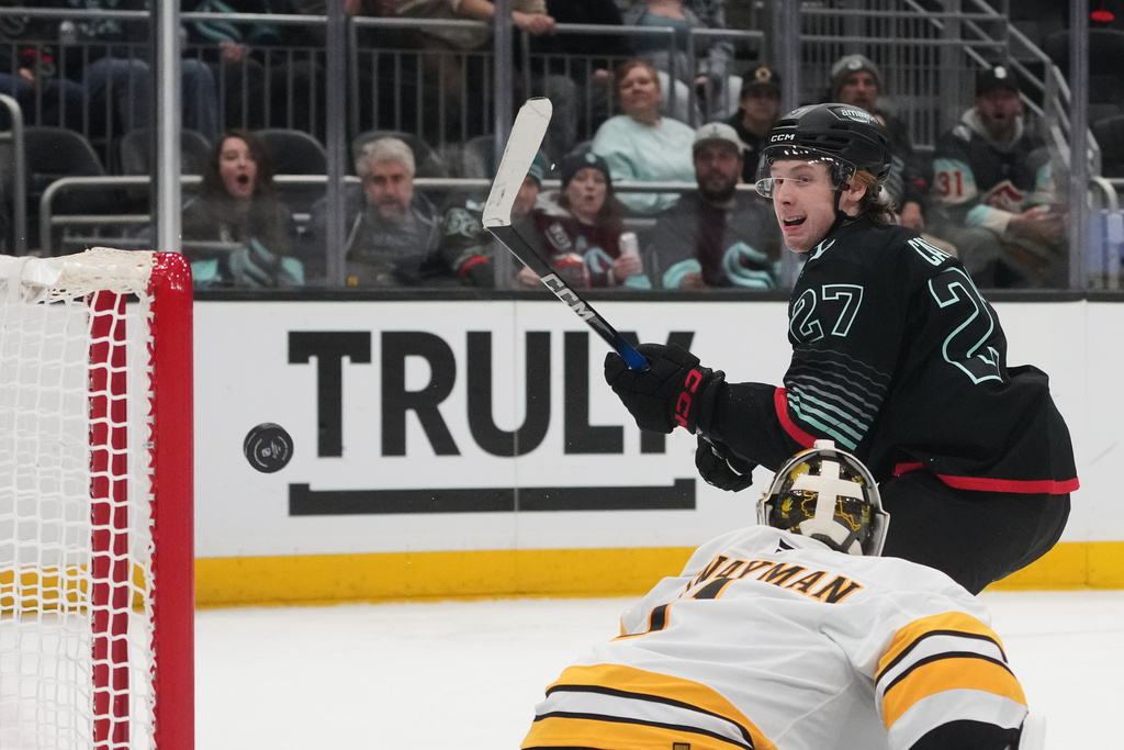 Seattle Kraken center Berkly Catton scores against Boston Bruins goaltender Jeremy Swayman during the third period of an NHL hockey game Tuesday, Jan. 6, 2026, in Seattle. (AP Photo/Lindsey Wasson)