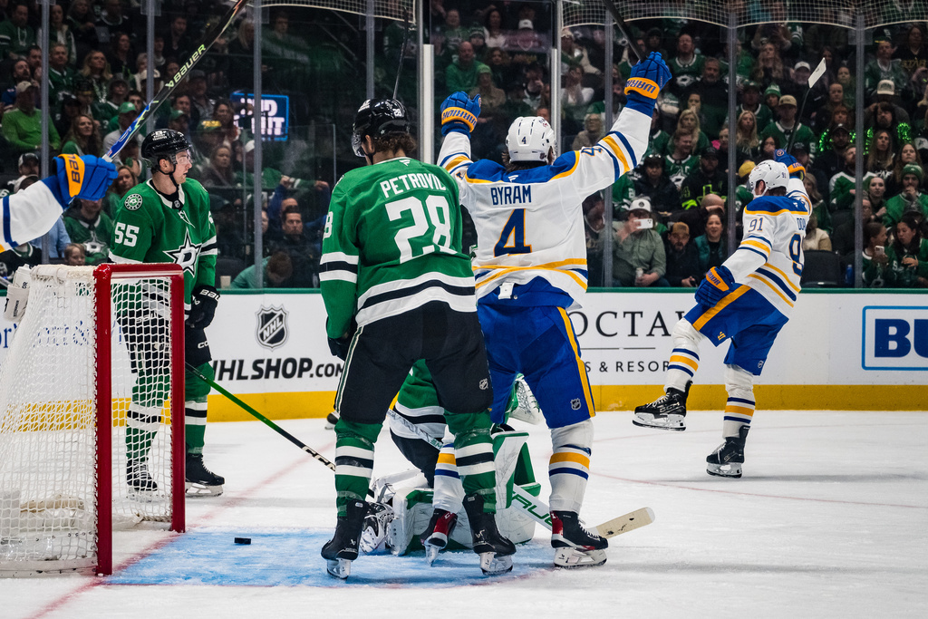 Buffalo Sabres defenseman Bowen Byram (4) and Buffalo Sabres right wing Josh Doan celebrate a goal during an NHL hockey game against the Dallas Stars, Wednesday, Dec. 31, 2025, Dallas. (AP Photo/Jessica Tobias)