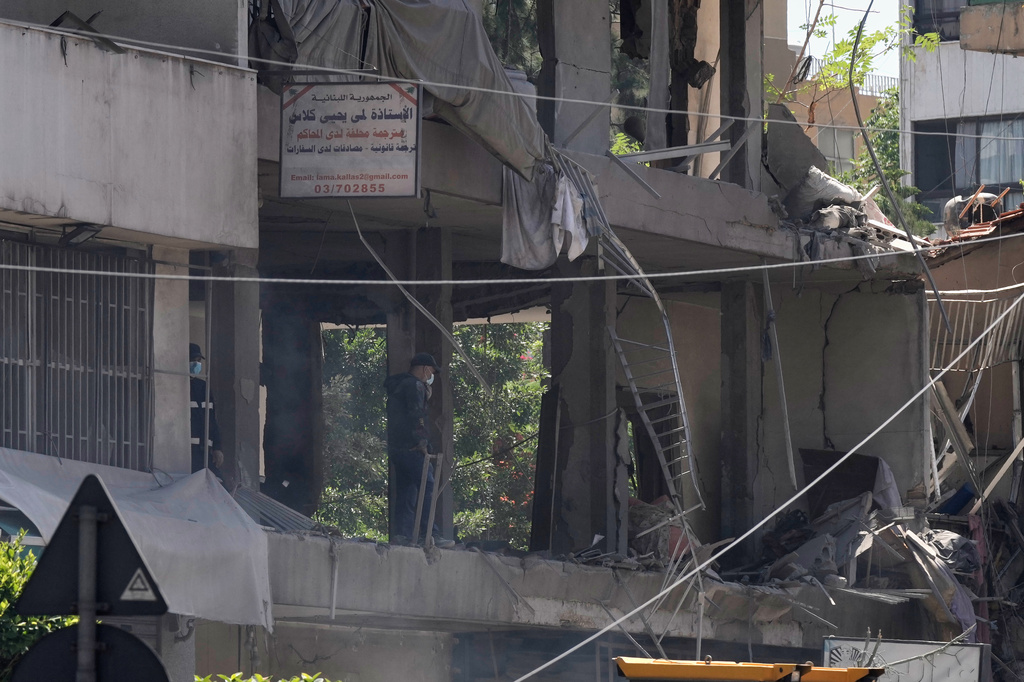 A man checks an apartment that was hit in an Israeli airstrike in Dahiyeh, Beirut's southern suburbs, Lebanon, Sunday, June 14, 2026. (AP Photo/Bilal Hussein)