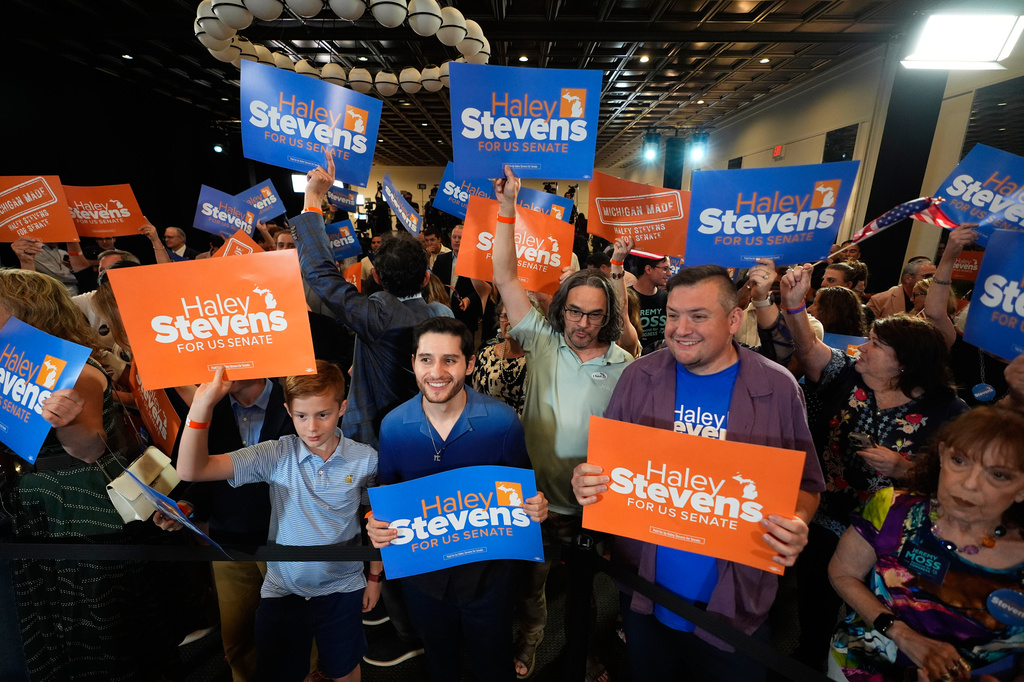 Attendees hold signs for Rep. Haley Stevens, D-Mich., a candidate in the Democratic primary for U.S. Senate in Michigan, during a primary election night event Wednesday, Aug. 5, 2026, in Detroit. (AP Photo/Paul Sancya)