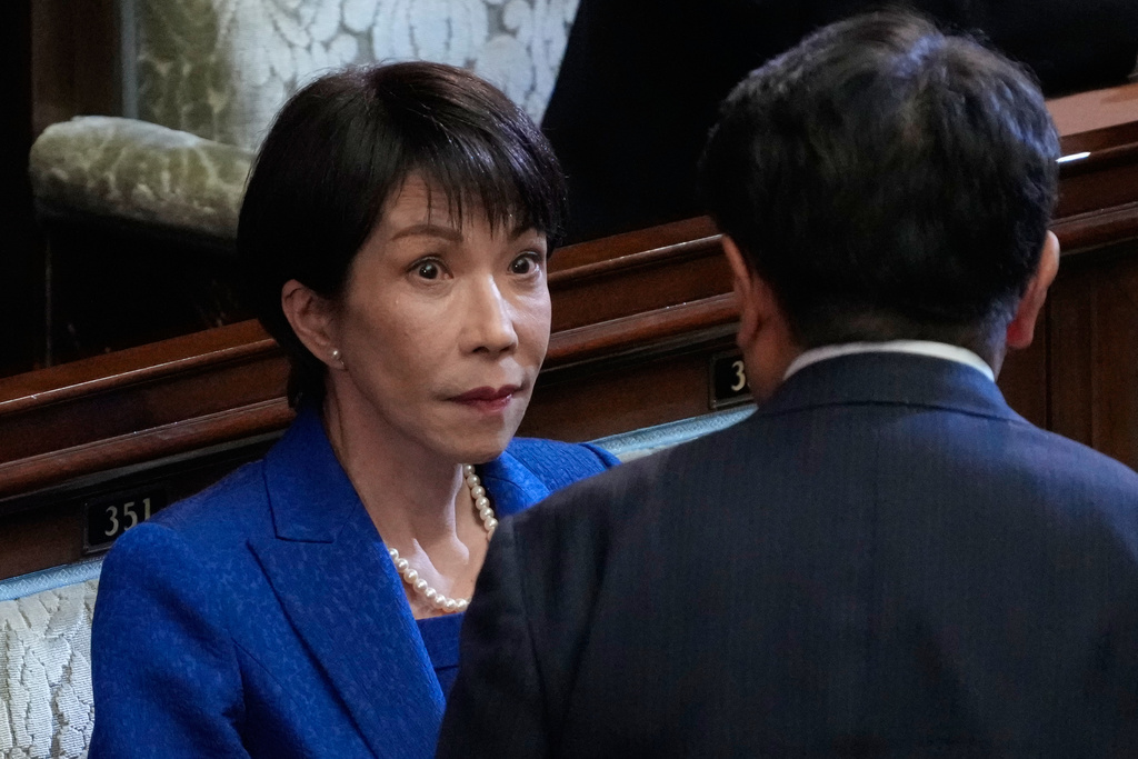 Japanese Prime Minister Sanae Takaichi, left, and a lawmaker speak before dissolving the lower house, during an extraordinary Diet session at the lower house of parliament Friday, Jan. 23, 2026, in Tokyo. (AP Photo/Eugene Hoshiko)