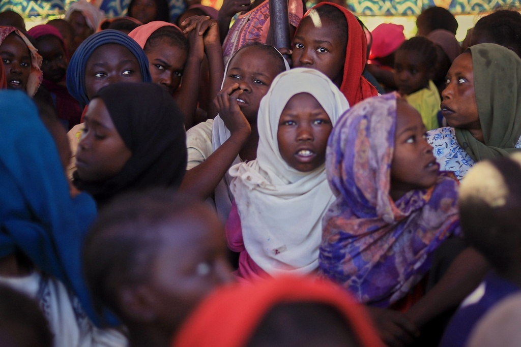 This photo released by The Norwegian Refugee Council (NRC), shows displaced women and children from el-Fasher at a camp where they sought refuge from fighting between government forces and the RSF, in Tawila, Darfur region, Sudan, Monday, Nov. 3, 2025. (NRC via AP)