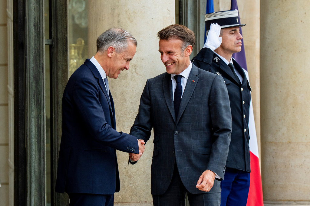 Canadian Prime Minister Mark Carney, left, is greeted by French President Emmanuel Macron at the Palais de l'Elysee in Paris, on Friday, June 12, 2026.(Christopher Katsarov /The Canadian Press via AP)