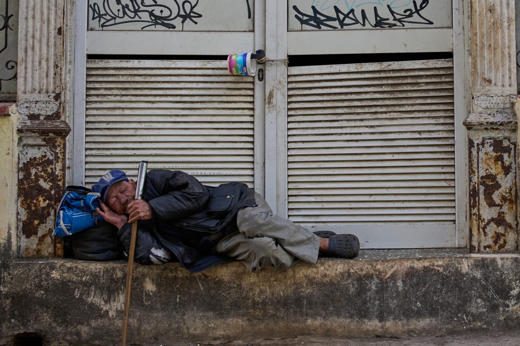 A man sleeps on a street in Havana, Tuesday, Feb. 24, 2026. (AP Photo/Ramon Espinosa)