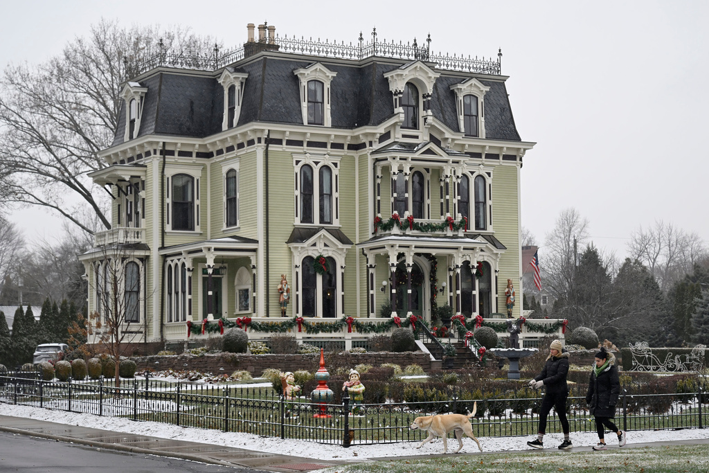 People walk by the Silas W Robbins B & B in Wethersfield, Conn., Saturday, Dec. 6, 2025, where parts of the Hallmark film "Christmas on Honeysuckle Lane" was filmed. (AP Photo/Jessica Hill)