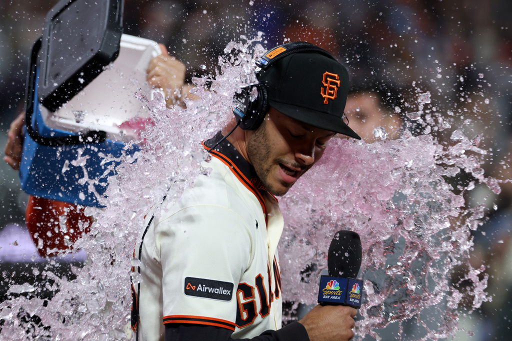 San Francisco Giants' Grant McCray is doused by teammates after their team's victory over the Milwaukee Brewers during a baseball game in San Francisco, Monday, July 27, 2026. (AP Photo/Jed Jacobsohn)