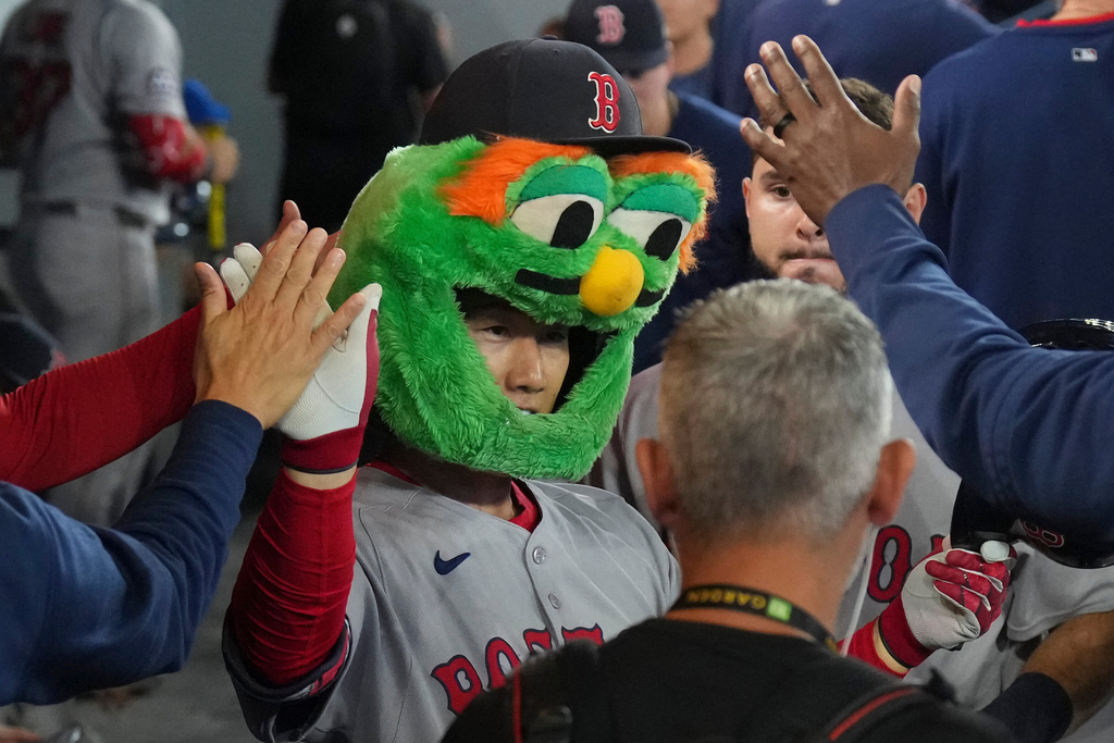 Boston Red Sox's Masataka Yoshida (7) celebrates in the dug out after hitting a solo home run off Toronto Blue Jays pitcher Max Scherzer (31) during fifth inning MLB baseball action in Toronto on Wednesday, Sept. 24, 2025. (Chris Young/The Canadian Press via AP)