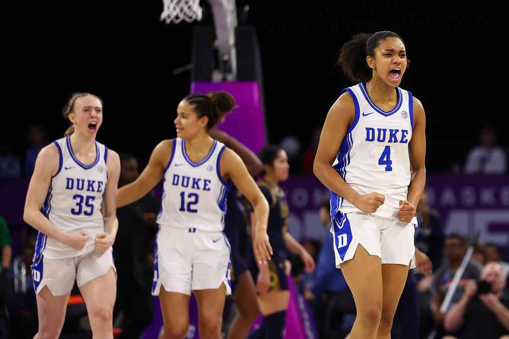 Duke forwards Toby Fournier (35), and Delaney Thomas (12), and guard Riley Nelson (4) react after an NCAA college basketball game in the semifinals of the Atlantic Coast Conference tournament against Notre Dame, Saturday, March 7, 2026, in Duluth, Ga. (AP Photo/Colin Hubbard)