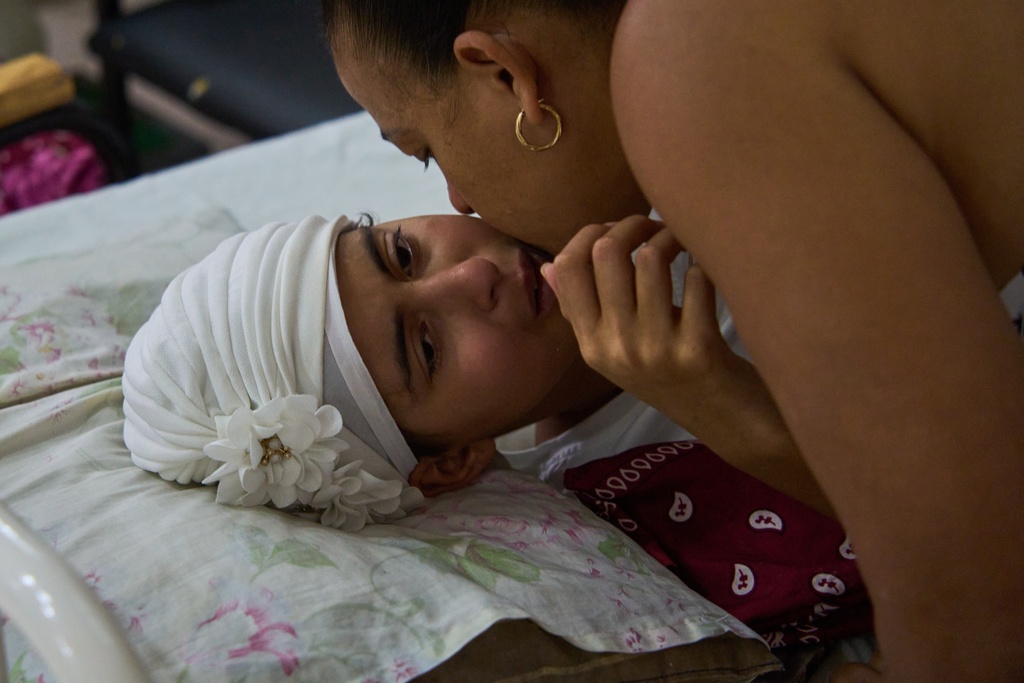 Niala Gonzalez, a cancer patient is kissed by her mother at the National Institute of Oncology and Radiology in Havana, Cuba, Friday, Feb. 20, 2026. (AP Photo/Ramon Espinosa)