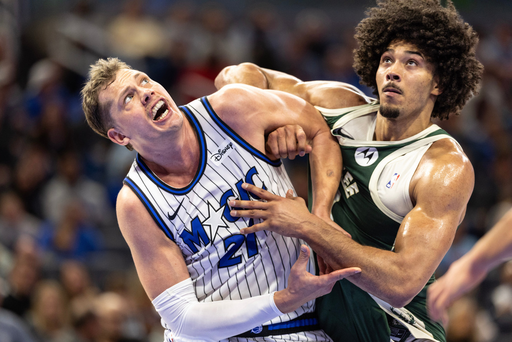 Orlando Magic forward/center Moritz Wagner, left, and Milwaukee Bucks center Jericho Sims fight for position on a rebound during the first half of an NBA basketball game, Wednesday, Feb. 11, 2026, in Orlando, Fla. (AP Photo/Willie J. Allen Jr.)