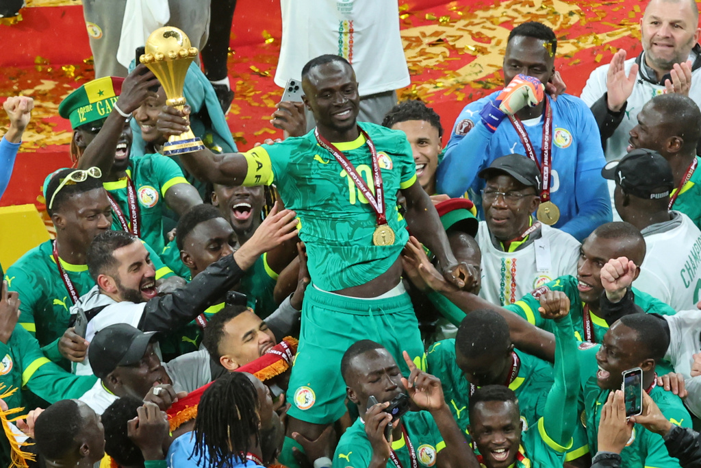 FILE - Senegal's Sadio Mane holds the trophy aloft as he celebrates with teammates after winning the Africa Cup of Nations final soccer match between Senegal and Morocco in Rabat, Morocco, Sunday, Jan. 18, 2026. (AP Photo/Youssef Loulidi, File)