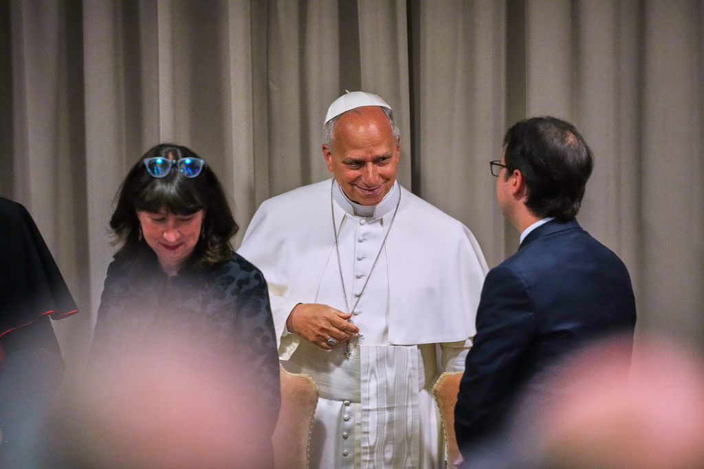 Pope Leo XIV, talks to Anthropic co-founder Christopher Olah, right, and theologian Anna Rowlands, left, during the presentation of his first encyclical, "Magnifica humanitas: On Safeguarding the Human Person in the Time of Artificial Intelligence," at the Vatican, Monday, May 25, 2026. (AP Photo/Alessandra Tarantino)
