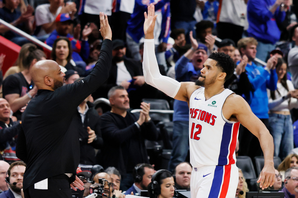 Detroit Pistons forward Tobias Harris (12) celebrates with head coach J.B. Bickerstaff, left, as he leaves late in the fourth quarter of a win over the Orlando Magic in Game 7 of a first-round NBA basketball playoffs series Tuesday, May 2, 2026, in Detroit. (AP Photo/Duane Burleson)