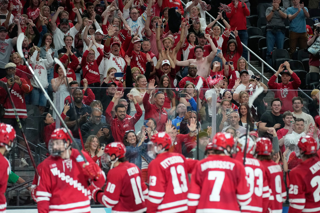 Fans celebrate after Wisconsin defeated North Dakota in a semifinal game of the NCAA Frozen Four men's college hockey tournament Thursday, April 9, 2026, in Las Vegas. (AP Photo/John Locher)
