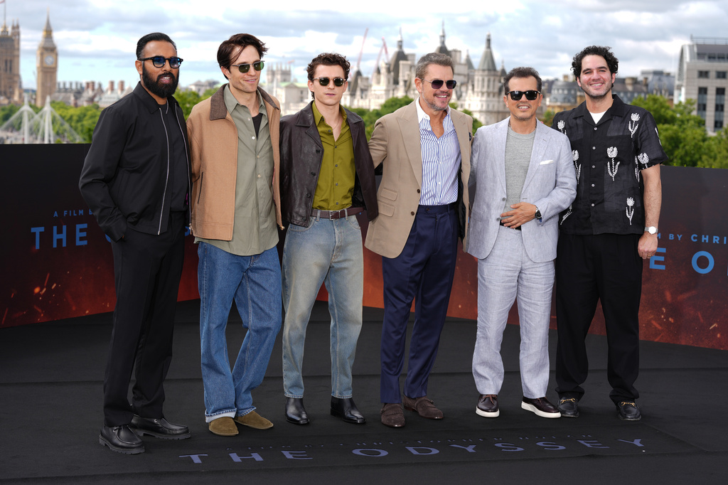 Himesh Patel, from left, Robert Pattinson, Tom Holland, Matt Damon, John Leguizamo and Benny Safdie pose for photographers upon arrival at the photo call for the film 'The Odyssey' on Sunday, July 5, 2026, in London. (Photo by Scott A Garfitt/Invision/AP)