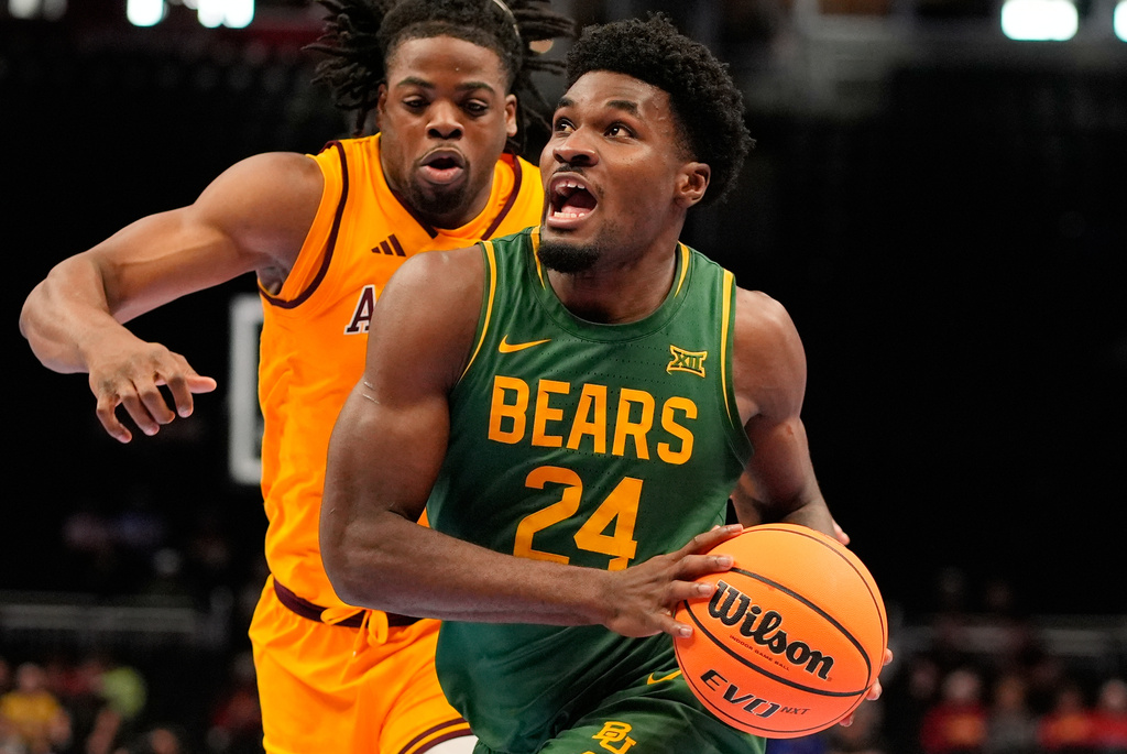 Baylor guard Tounde Yessoufou (24) looks to shoot under pressure from Arizona State forward Allen Mukeba during the first half of an NCAA college basketball game at the Big 12 Conference tournament Tuesday, March 10, 2026, in Kansas City, Mo. (AP Photo/Charlie Riedel)