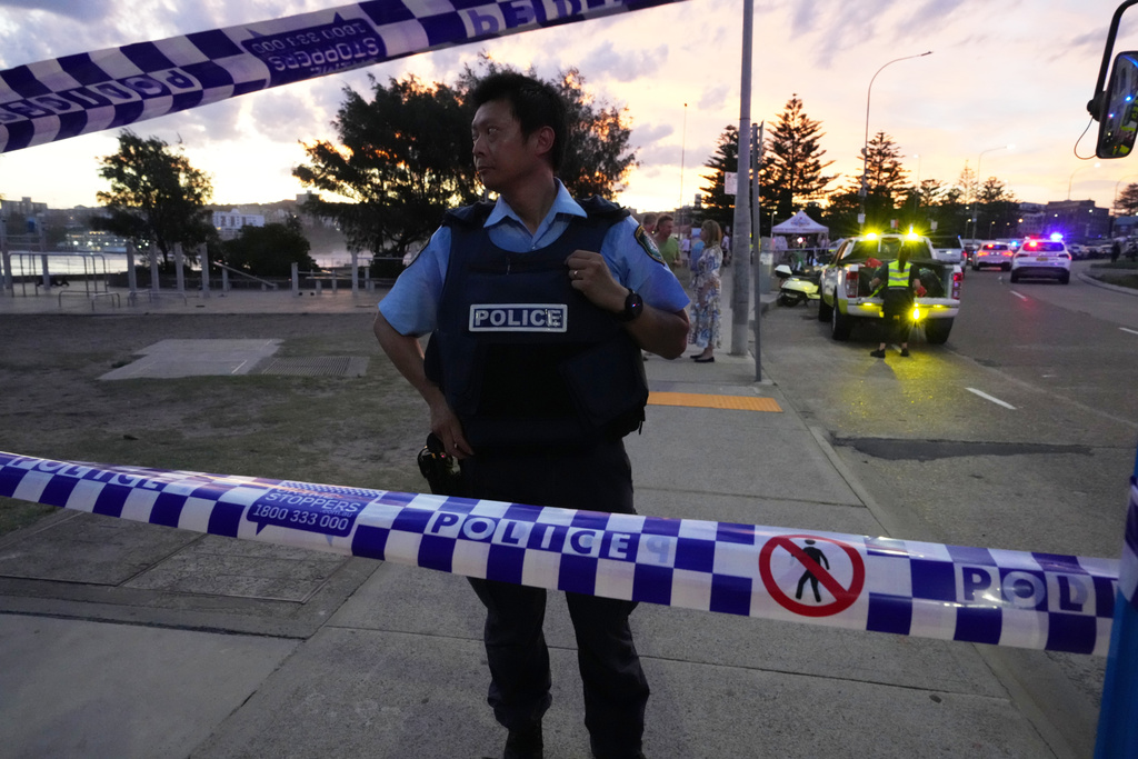 Police cordon off an area at Bondi Beach after a reported shooting in Sydney, Sunday, Dec. 14, 2025. (AP Photo/Mark Baker)