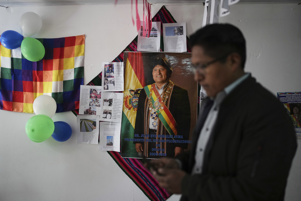 Guido Ramirez, supporters of former President Evo Morales, stands near a poster of Morales at a campaign center for Morales supporters who are in favor of a null vote in the upcoming presidential election in El Alto, Bolivia, Tuesday, Aug. 12, 2025. (AP Photo/Natacha Pisarenko)