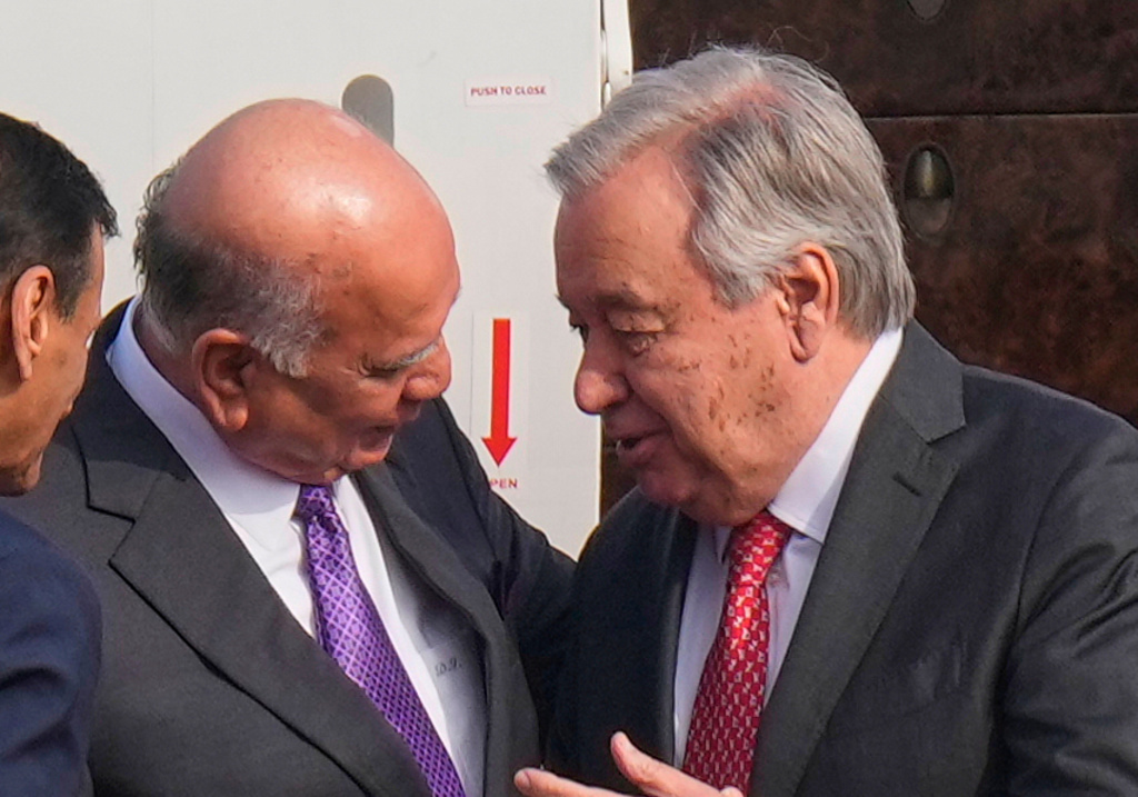 Iraqi Foreign Minister Fouad Hussein, left, greets United Nations Secretary-General Antonio Guterres, right, at Baghdad airport, Iraq, Saturday, Dec.13, 2025. (AP Photo/Hadi Mizban)