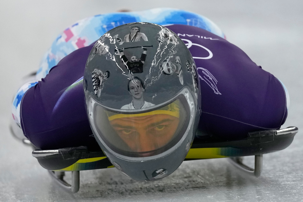 Ukraine's Vladyslav Heraskevych starts for a men's skeleton training session at the 2026 Winter Olympics, in Cortina d'Ampezzo, Italy, Wednesday, Feb. 11, 2026. (AP Photo/Aijaz Rahi)