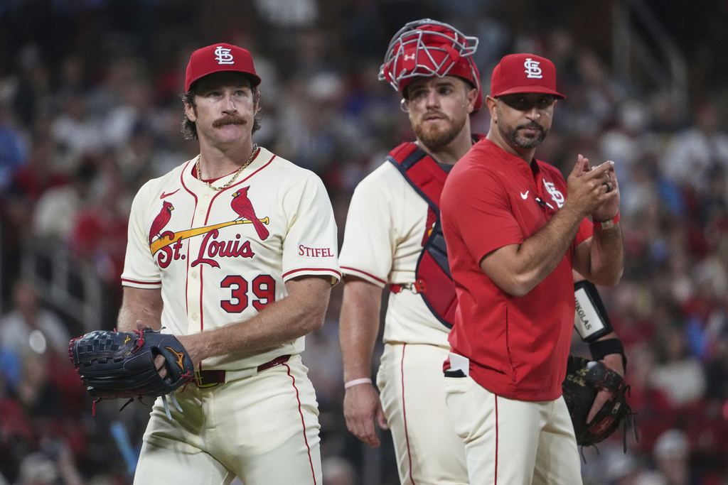 St. Louis Cardinals' Miles Mikolas (39) is removed by manager Oliver Marmol, right, as catcher Pedro Pages watches during the sixth inning of a baseball game against the Milwaukee Brewers Saturday, Sept. 20, 2025, in St. Louis. (AP Photo/Jeff Roberson)