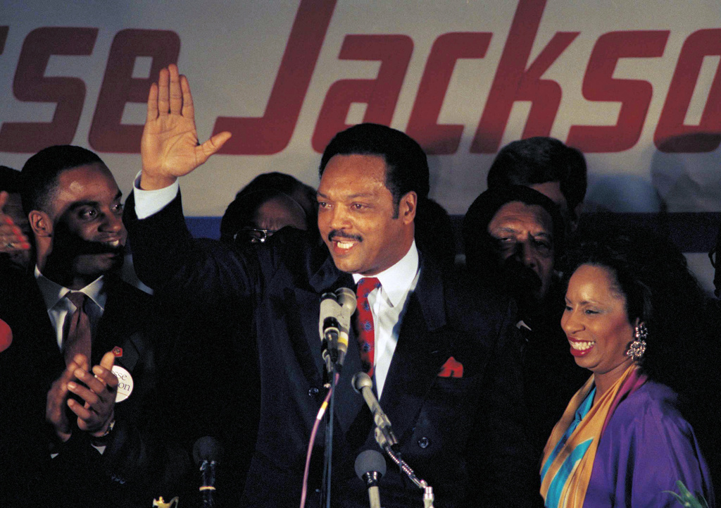 FILE - Jesse Jackson, with his wife Jacqueline, concedes defeat in the Illinois Democratic primary on March 16, 1988, in Chicago. (AP Photo/Lisa Genesen, File)