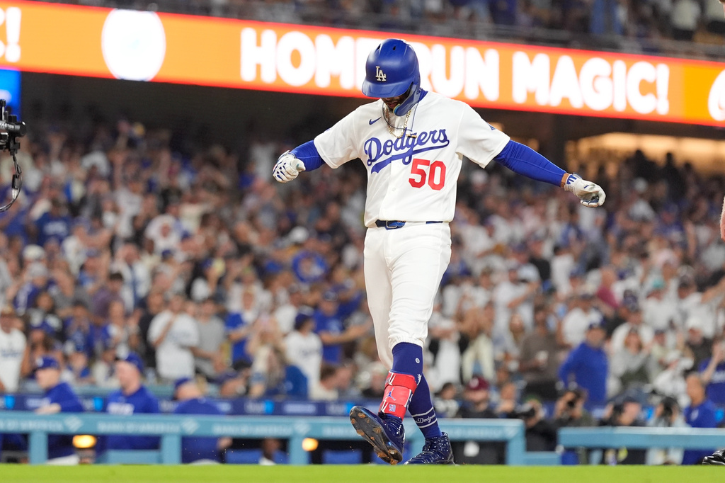 Los Angeles Dodgers' Mookie Betts scores after hitting a solo home run during the first inning of a baseball game against the San Francisco Giants, Friday, Sept. 18, 2026, in Los Angeles. (AP Photo/Mark J. Terrill)