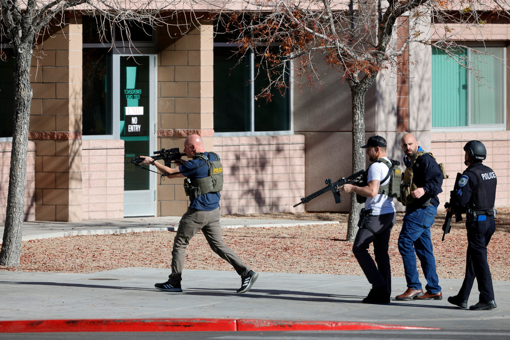 FILE - Law enforcement officers head into the University of Nevada, Las Vegas, campus after reports of an active shooter, Wednesday, Dec. 6, 2023, in Las Vegas. (Steve Marcus/Las Vegas Sun via AP, File)