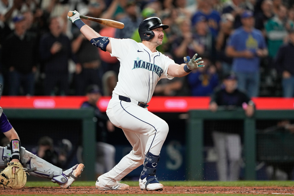 Seattle Mariners' Cal Raleigh watches his 60th home run during the eighth inning of a baseball game against the Colorado Rockies, Wednesday, Sept. 24, 2025, in Seattle. (AP Photo/Ryan Sun)