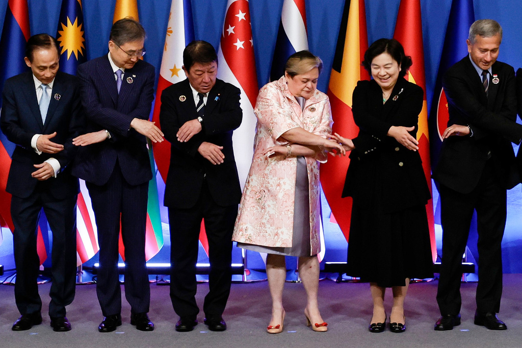 From left, Vietnam's Foreign Minister Le Hoai Trung, South Korean Foreign Minister Cho Hyun, Japan's Foreign Minister Toshimitsu Motegi, Philippine Foreign Secretary Theresa Lazaro, China's Vice Minister of Foreign Affairs Hua Chunying and Singapore's Foreign Minister Vivian Balakrishnan prepare to link arms for a group photo during the 27th Assocation of Southeast Asian Nations (ASEAN) Plus Three Foreign Ministers' Meeting in Pasay City, Metro Manila, Philippines Thursday, July 23, 2026. (Rolex Dela Pena/Pool Photo via AP)