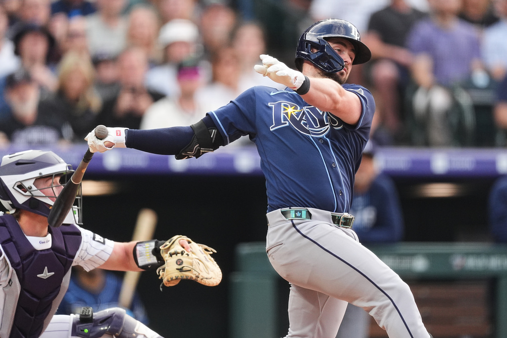 Tampa Bay Rays' Liam Hicks follows the flight of his grand slam off Colorado Rockies starting pitcher Gabriel Hughes in the third inning of a baseball game Tuesday, Aug. 4, 2026, in Denver. (AP Photo/David Zalubowski)