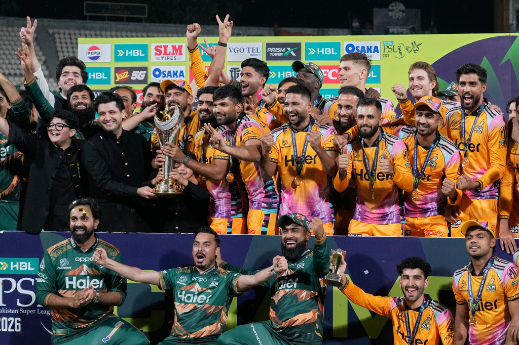 Officials and players of Peshawar Zalmi celebrates as they pose for photo with trophy after winning the Pakistan Super League final cricket match against Hyderabad Kingsmen, in Lahore, Pakistan, Monday, May 4, 2026. (AP Photo/K.M. Chaudary)