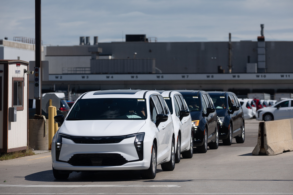 Chrysler Pacificas are driven off the lot at Windsor Assembly Plant in Windsor, Ontario, Canada, on Monday, Aug. 24, 2026. (Dax Melmer/The Canadian Press via AP)