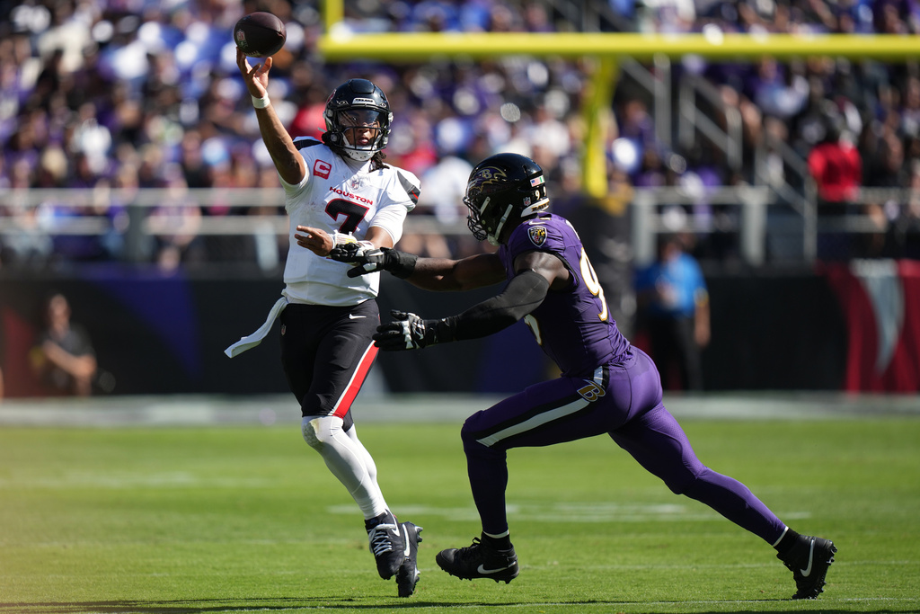 Houston Texans quarterback C.J. Stroud (7) throws against Baltimore Ravens linebacker Odafe Oweh (99) during the first half of an NFL football game, Sunday, Oct. 5, 2025, in Baltimore. (AP Photo/Stephanie Scarbrough)