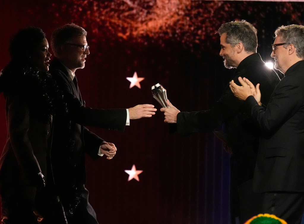 Teyana Taylor, from left, and Paul Thomas Anderson accept the award for best picture for "One Battle After Another" from Wagner Moura and Kleber Mendonca Filho during the 31st Annual Critics Choice Awards on Sunday, Jan. 4, 2026, at The Barker Hanger in Santa Monica, Calif. (AP Photo/Chris Pizzello)